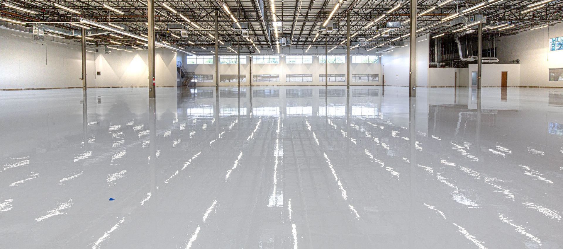 Spacious and polished industrial facility with glossy epoxy flooring in Houston, Texas.